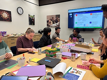 group working together at a large table on crafts