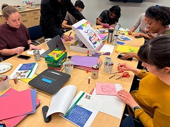 group working at large table with craft supplied