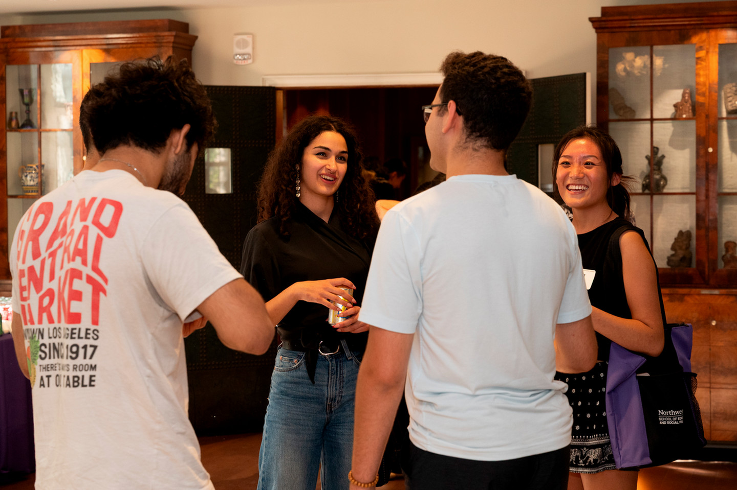 Student standing in a circle talking.