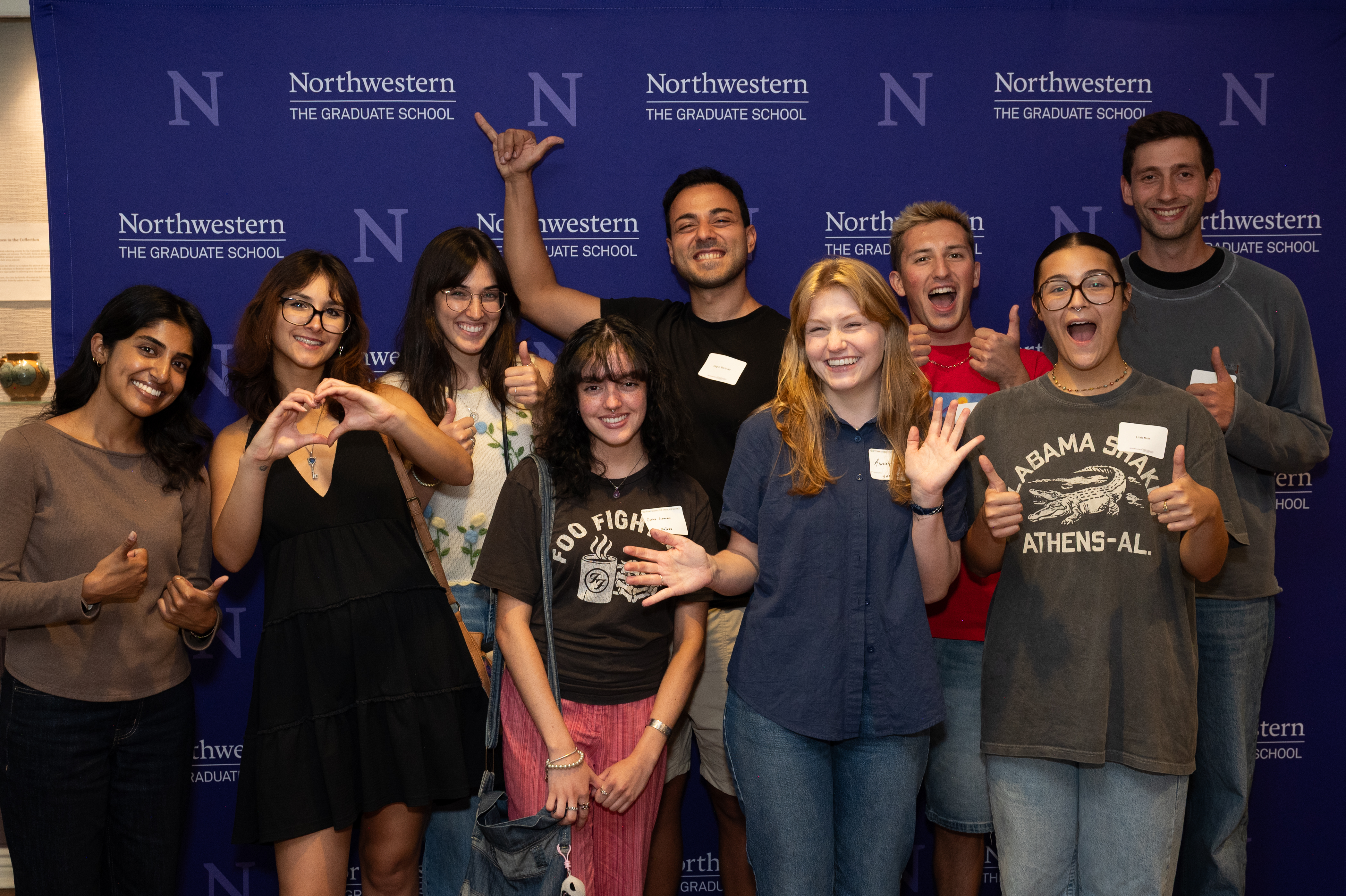 Students posing in front of the Northwestern banner.